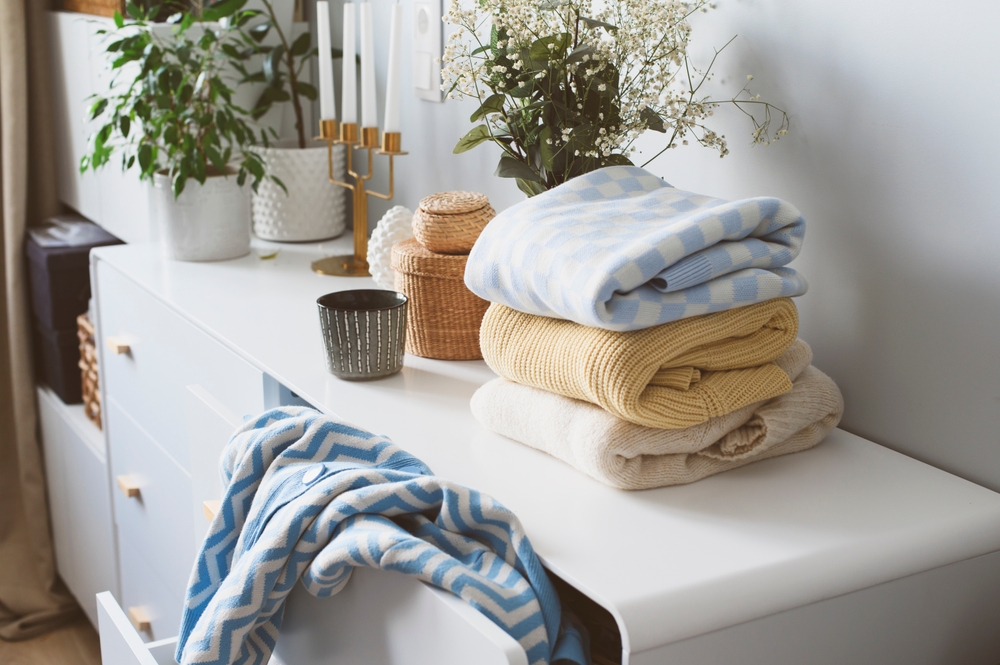 White,Scandi,Drawer,With,Stack,Of,Patterned,Knitted,Sweaters.,Spring
